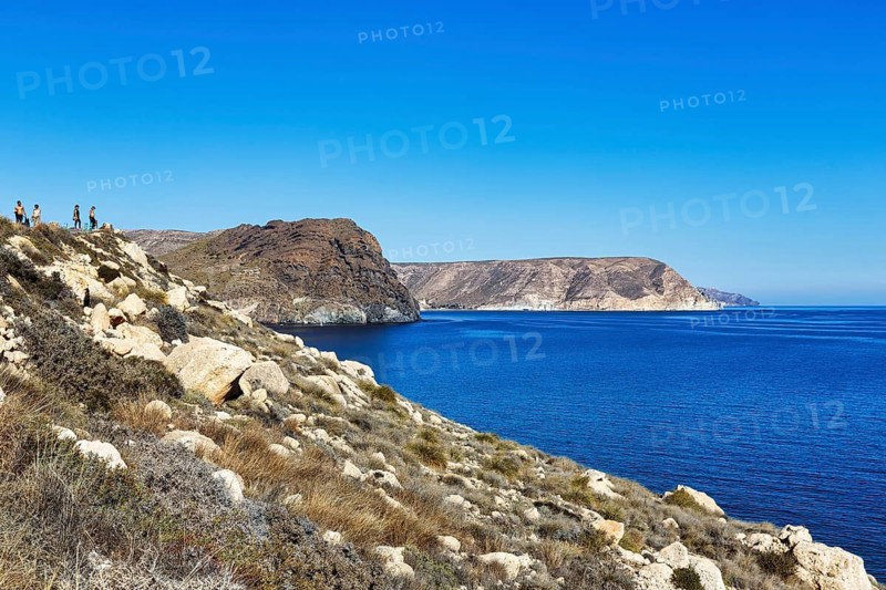 Hikers on rocky coast, Cabo de Gata-Nijar nature park Park, Las Negras, Nijar, Almeria, Andalusia, Spain