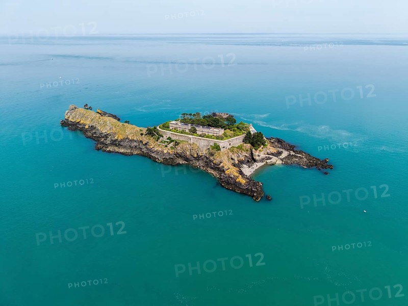 Aerial view of the historic Île des Rimains fortress island with the Fort des Rimains in the turquoise sea. The former lake-fort is located off the coast of the municipality of Cancale, Côte d'Émeraude, Emerald Coast, Ille-et-Vilaine department, Brittany, English Channel, France
