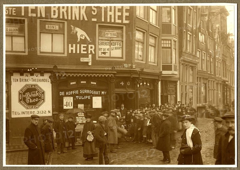 Amsterdam, the Netherlands, shops, tea shops, onlookers, people standing on a historic street in front of a building with old advertising signs, P. Steensma, twenties, around 1920