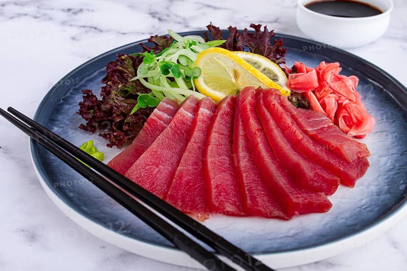 Tuna sashimi, with side dish, on a marble table, homemade, no people