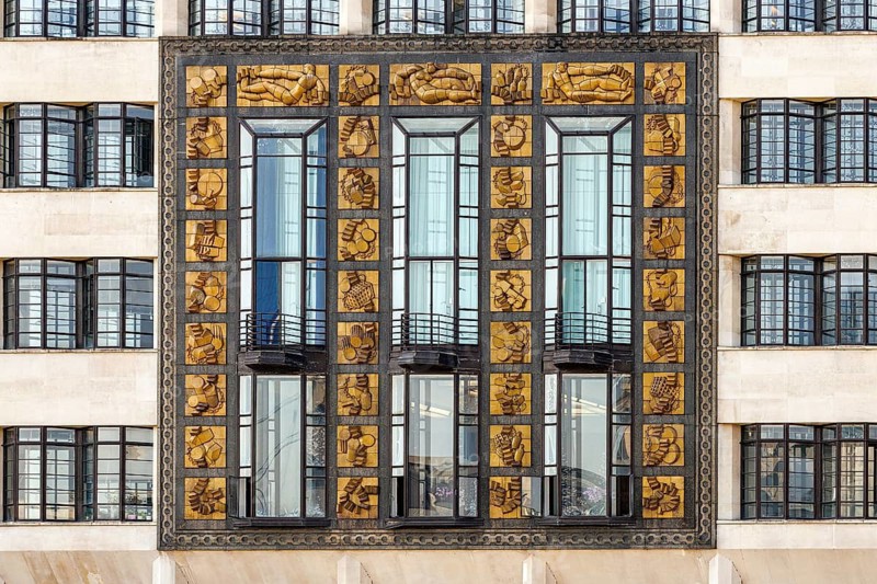 The gilded Frank Dobson relief panels on the Art Deco facade of St Olaf House, London Bridge Hospital, Tooley Street, London, England, United Kingdom