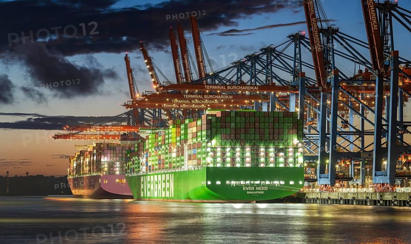 Aerial view at Waltershof harbour during the Blue Hour at Container Terminal Burchardkai (CTB) with the brightly lit Ever Meed (Evergreen), Hamburg, Germany