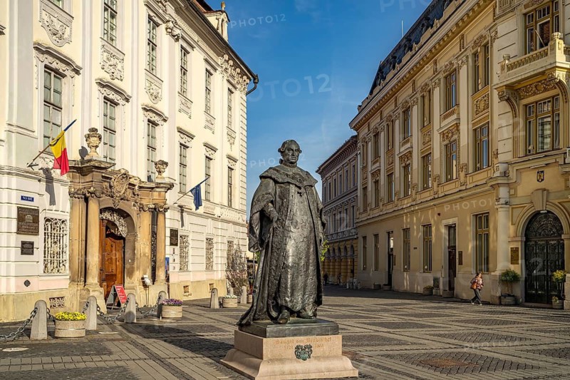 Statue of Samuel of Brukenthal in front of the Brukenthal Museum and City Hall on the Pia?a Mare Great Ring at dusk, Sibiu or Sibiu, Transylvania, Romania