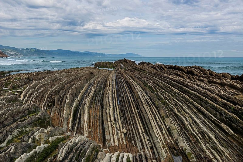 Distinctive rock cliffs as a geological formation of rock layers, Flysch on Itzurun Beach in Zumaia, Spain