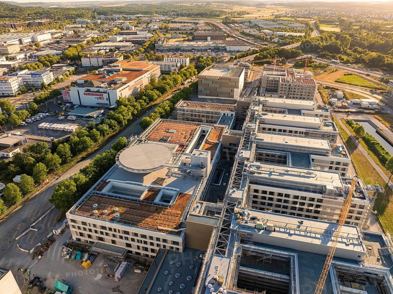 Extensive industrial buildings and urban environment with detailed roof structures, construction site of the new airfield clinic, Böblingen, Germany