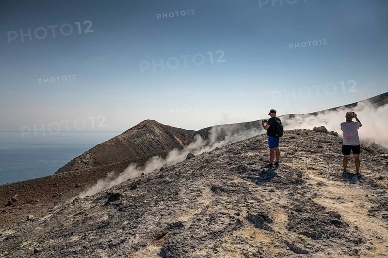 Tourists stand at the crater rim and photograph rising sulfur clouds, Vulcano, Aeolian or Lipari islands, Sicily, southern Italy, Italy