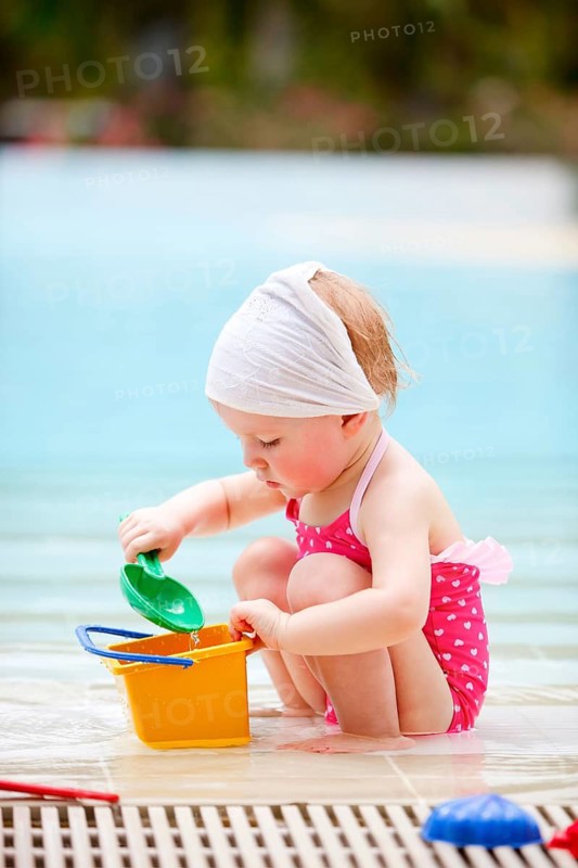 A little girl playing at the pool, La Digue, Indian Ocean, Seychelles
