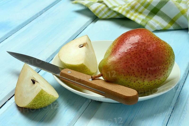 Pears on plate, cut with knife
