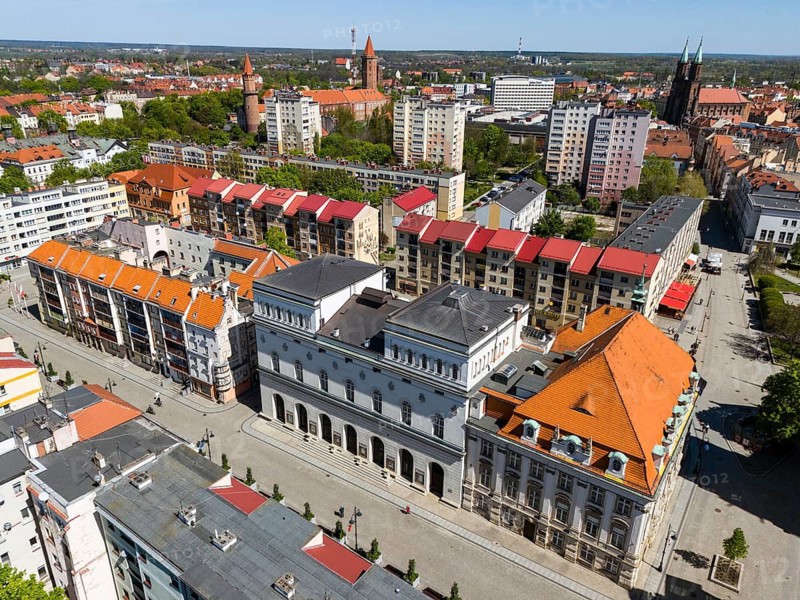 Urban aerial view with historic buildings and red roofs surrounded by trees and roads, aerial view, Modrzejewska Theatre in the middle, Old Town Hall, Legnica, Liegnitz, Lower Silesia Voivodeship, Poland