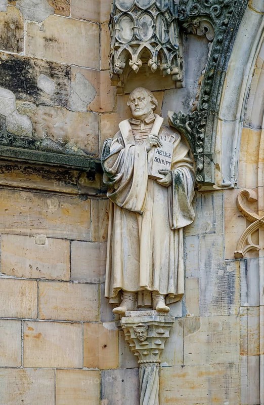 Statue of Martin Luther on the façade of the Protestant Margaret Church, late Gothic hall church, Neumarkt, Gotha, Thuringia, Germany
