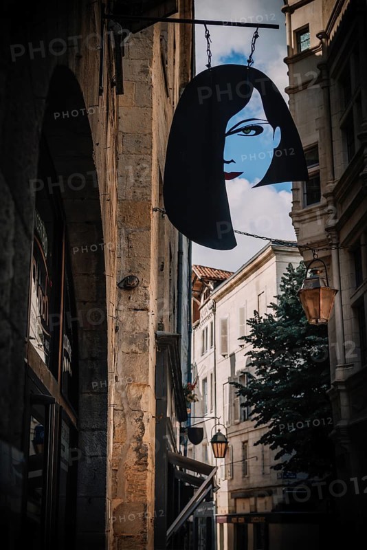 Guild sign of a hairdressing salon in the old town of Pèrigueux, Dordogne, France