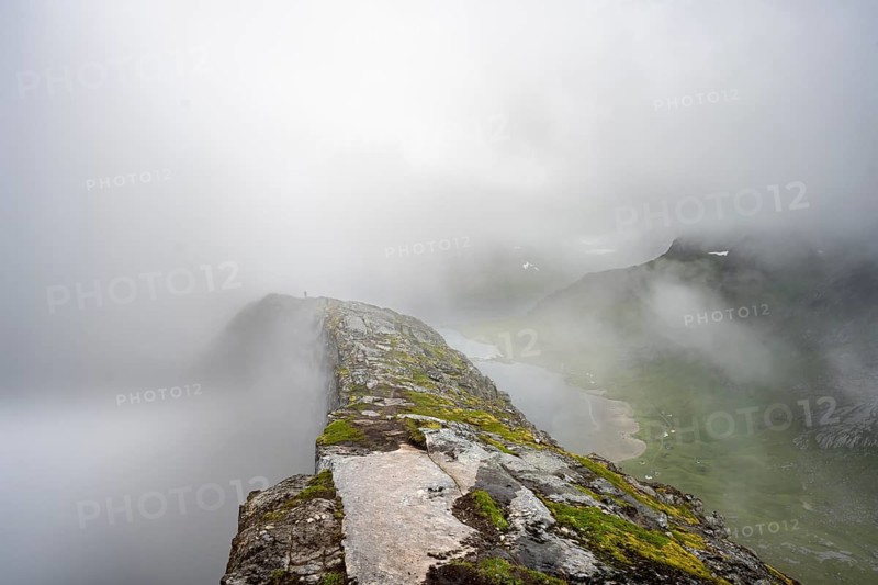 Helvetestinden summit, cloud-covered mountain landscape with summit ridge, Lofoten, Norway