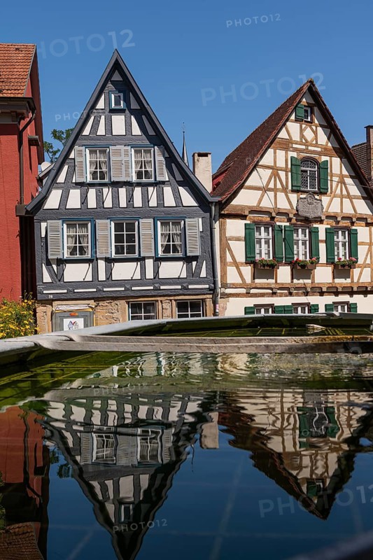 Birthplace (right) of Friedrich Schiller (1759 Marbach, 1805 Weimar), Niklastorstrasse 31, Schiller Society building (left), reflection in the Wilde-Mann fountain, Schiller's town of Marbach am Neckar, half-timbered house, gable, poet, writer, playwright, lyricist, Friedrich Schiller, 1759, birth, literary history, German Classicism, Weimar Classicism, memorial site, museum, historic old town, veneration of Schiller, literary legacy, poet's house, cultural history, Baden-Württemberg, Germany