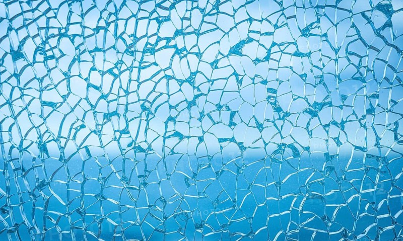 Frozen abstract texture resembling winter frost or cracked ice surface. Delicate crystalline pattern with cold blue tones creating seasonal atmosphere, frozen nature background and icy winter feeling