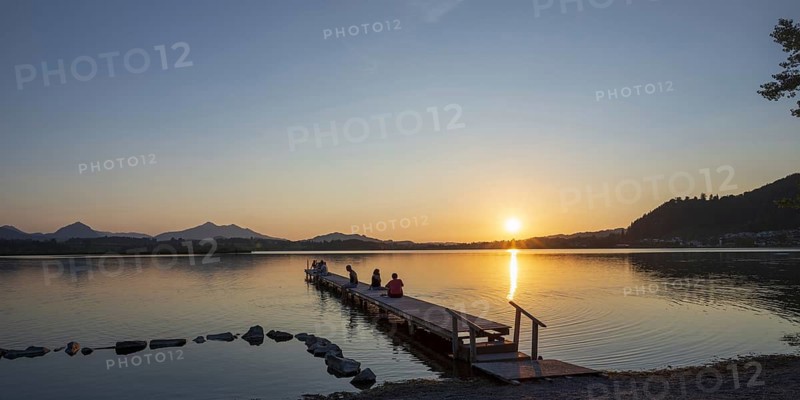 People enjoy sunset at Hopfensee near Füssen, Ostallgäu, Allgäu, Upper Swabia, Swabia, Bavaria, Germany