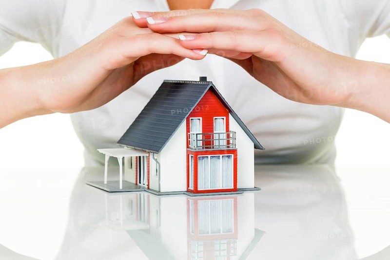 A woman protects her house and home. Good insurance and serious financing reassure