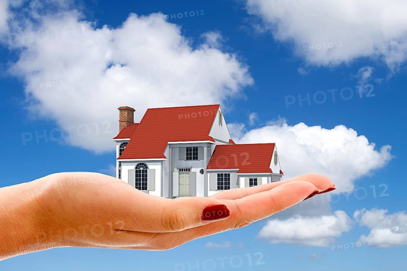 Hand with single-family house, cumulus clouds, blue sky, dream home, construction financing, mortgage, loan, East Frisia, Lower Saxony, Federal Republic of Germany