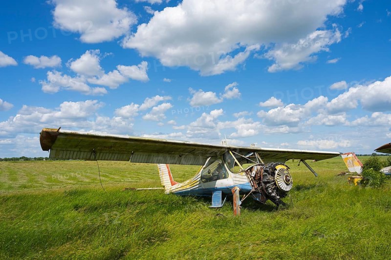 An old aircraft without an engine is resting on a vast green area under a cloudy sky, PZL-104 Wilga multi-purpose aircraft, abandoned airport, Ceadir-Lunga, Ceadîr-Lunga, Chadyr-Lunga, Taraclia district, Gagauzia autonomous region, Republic of Moldova, Moldova