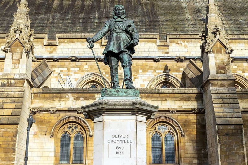 The bronze figure of Oliver Cromwell by Hamo Thornycroft stands before the medieval facade of Westminster Hall, London, England, United Kingdom