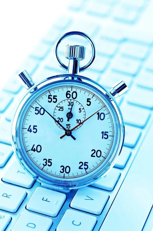 A stopwatch is placed on a computer keyboard. Office hours, timekeeping, stopwatch, Vienna, Austria
