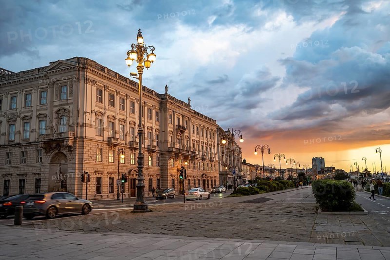 Magnificent Palazzo del Lloyd Triestino on the Riva del Mandracchio seafront, dramatic clouds at sunset, Trieste, Friuli-Venezia Giulia region, Italy