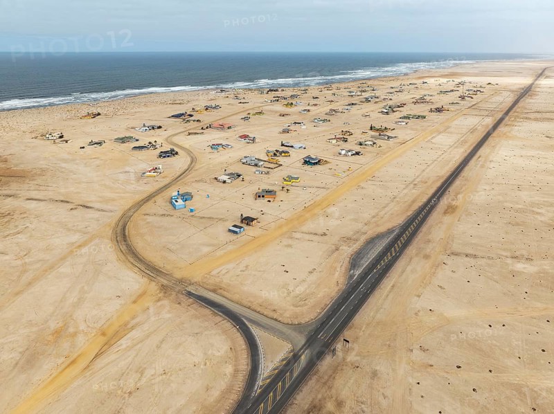 The odd holiday settlement of Wlotzkasbaken at the Atlantic coast. Aerial view. Drone shot. Namib Desert, Skeleton Coast, Namibia
