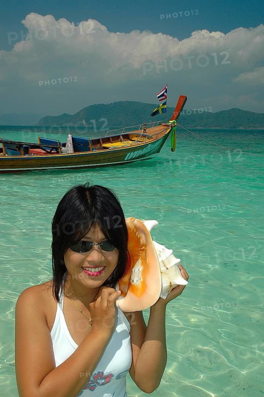Thai woman with large mussel on her ear, Thailand