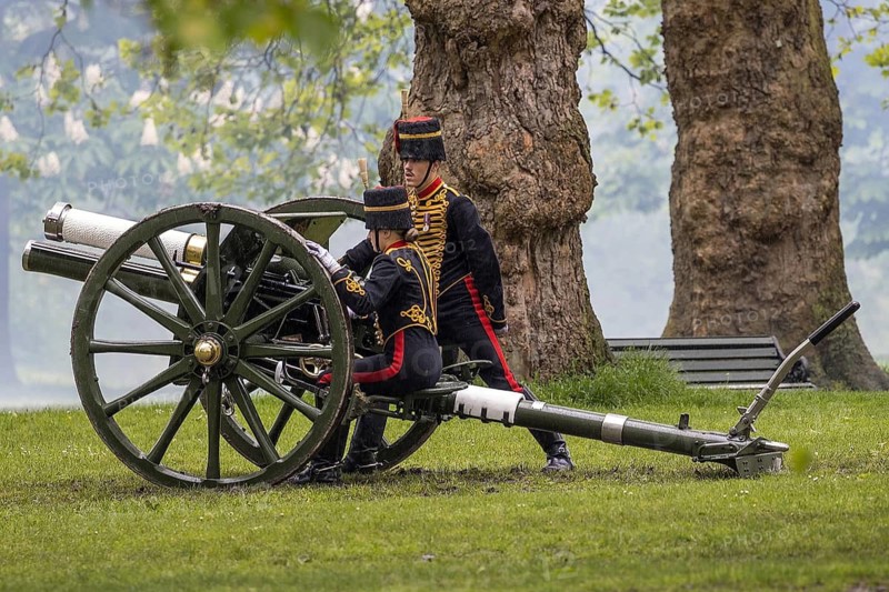 Two gunners of the King's Troop Royal Horse Artillery ready a First World War era field gun before firing in Green Park