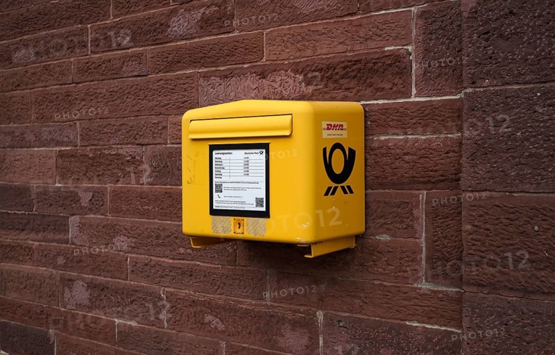 Letter box, mail box, yellow, on house wall, DHL, Deutsche Post, logo, Keplerstadt, Weil der Stadt, Baden-Württemberg, Germany