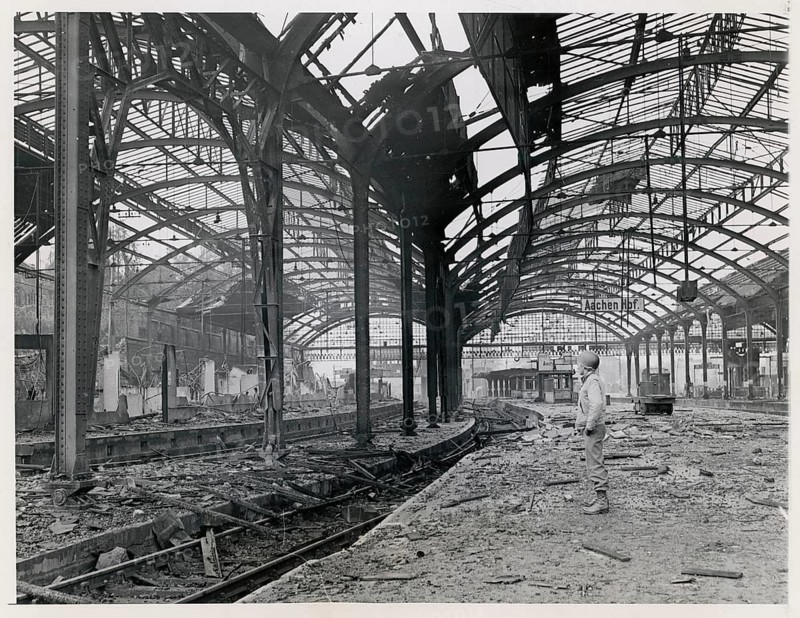 Aachen Central Station, destroyed, rubble, World War II, A destroyed train station with damaged roof structure and piled rubble, 30.10.1944