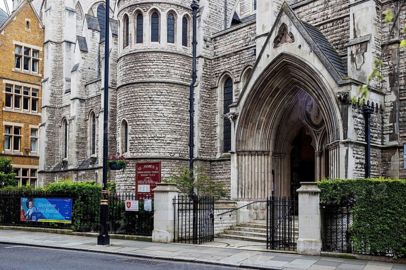 The Gothic entrance and tower of St James's Roman Catholic Church at Spanish Place, Marylebone, London, England, United Kingdom