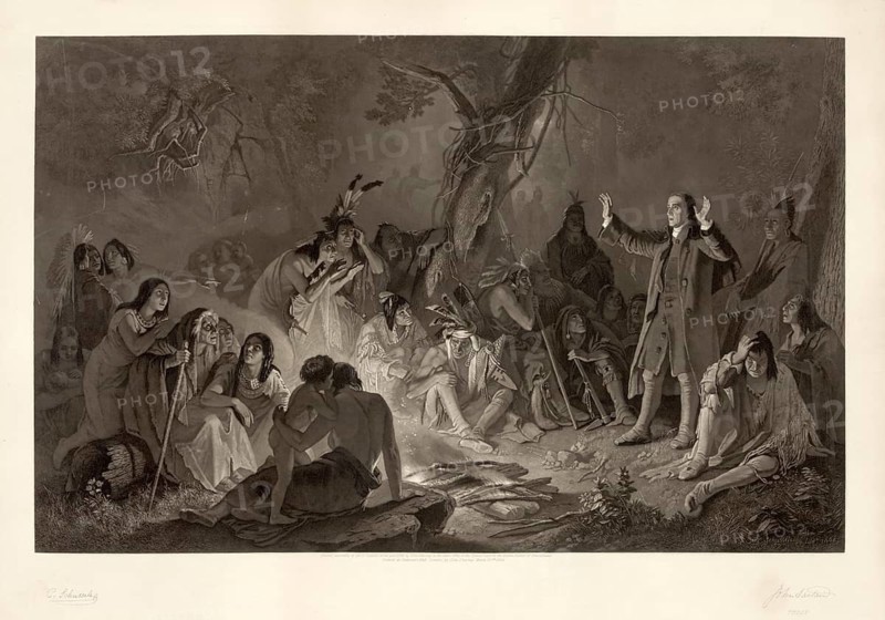 The picture shows the Moravian missionary David Zeisberger speaking to Native Americans (Delaware/Lenape) in the forests of Pennsylvania in the 18th century. Zeisberger (1721–1808) was a prominent missionary of the Moravian Church who lived amongst the Lenape for many years, learnt their language and worked to Christianise and protect the indigenous people, American history, authentic, digitally restored high-resolution reproduction from a 19th-century original, exact date of the depiction unknown, historical