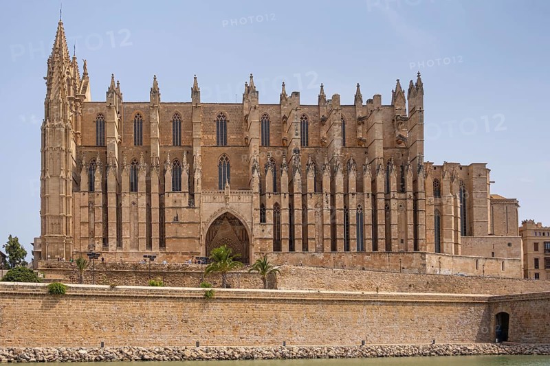 Palma Cathedral, also known as La Seu, is Palma's landmark and is one of the most important Gothic buildings in Europe. It was built from 1229 on the remains of a former mosque and impresses with its huge rose window and its location right by the sea. In the 20th century, Antoni Gaudí redesigned parts of the interior and gave the cathedral additional architectural accents, Palma, Majorca