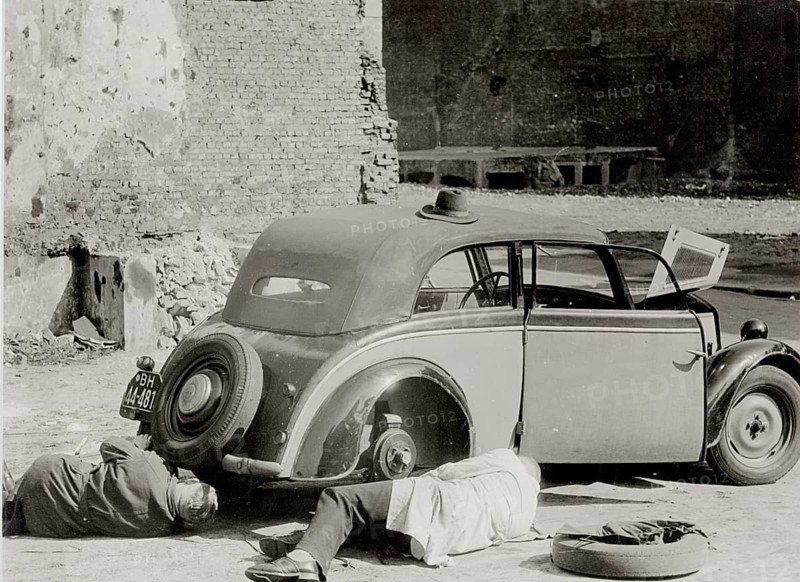 Hamburg, car repair, war damage, post-war period, two men repair an old car on a deserted street, John Holler, 1946