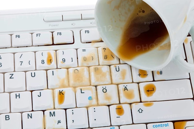 Coffee mug poured out on a computer keyboard. Insurance damage, Austria