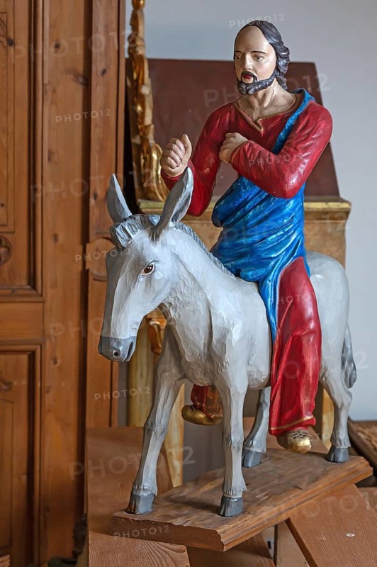 Palm tree, late Gothic figure of Christ, modern donkey, parish church of St. Lawrence, Otzing, Deggendorf district. Lower Bavaria, Germany