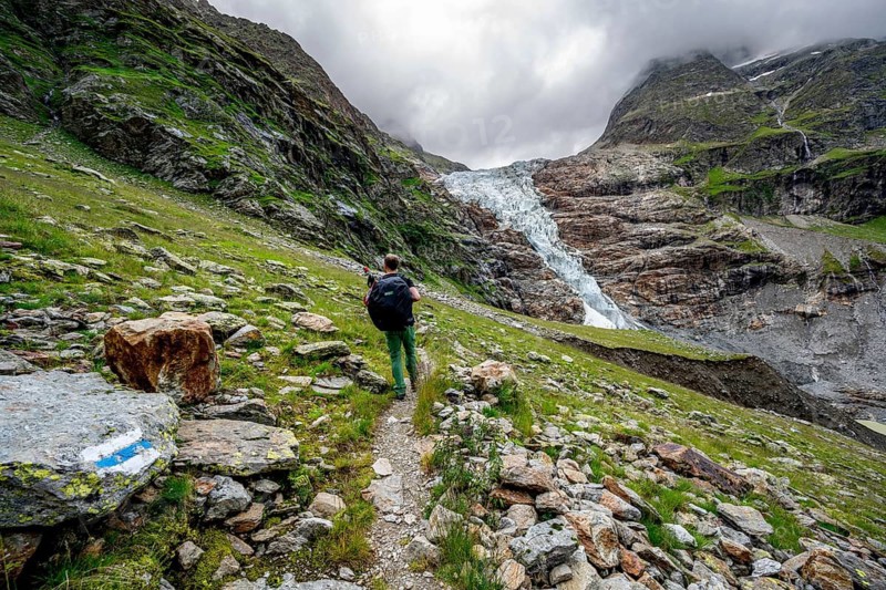Mountaineers on a hiking trail, dramatic mountain landscape with Lower Arctic Sea glacier, Bernese Alps, Bernese Oberland, Switzerland