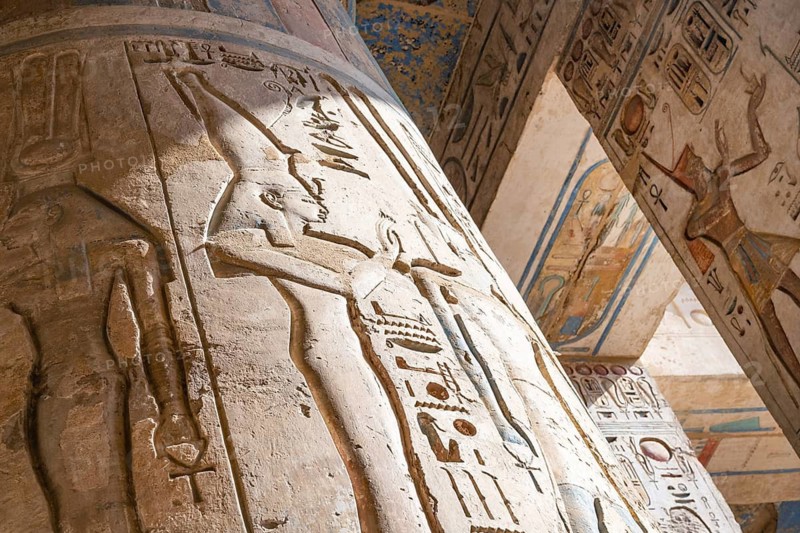 Close up details of ancient Egyptian history shown in reliefs and hieroglyphs inside Medinat Habu, the ancient Egyptian Mortuary Temple of Ramesses III on the West Bank of The Nile, Luxor, Egypt