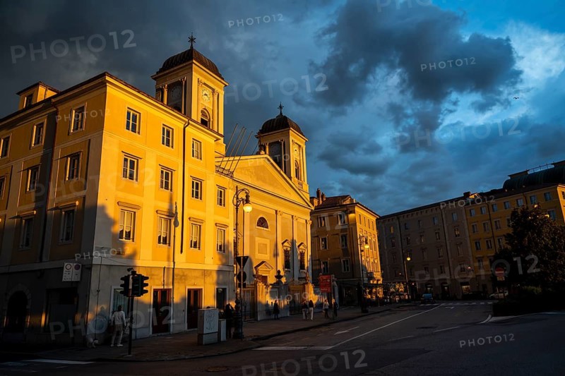 San Nicolò Greek Orthodox Church on the Riva del Mandracchio seafront in the evening light at sunset, dramatic clouds and atmospheric lighting, Trieste, Friuli-Venezia Giulia region, Italy