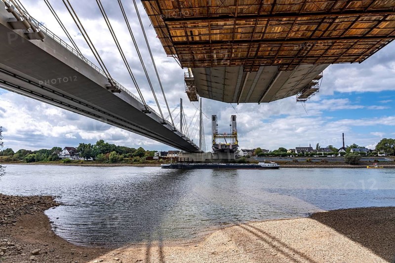 New construction of the second part of the Neuenkamp motorway bridge of the A40, across the Rhine near Duisburg, parallel to the existing first bridge, freighter on the Rhine, North Rhine-Westphalia, Germany