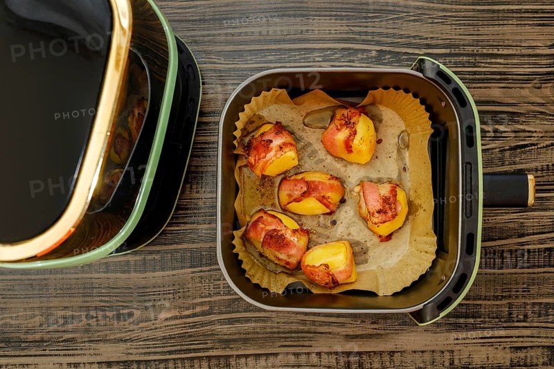 Top view of potatoes wrapped in bacon baked in air fryer
