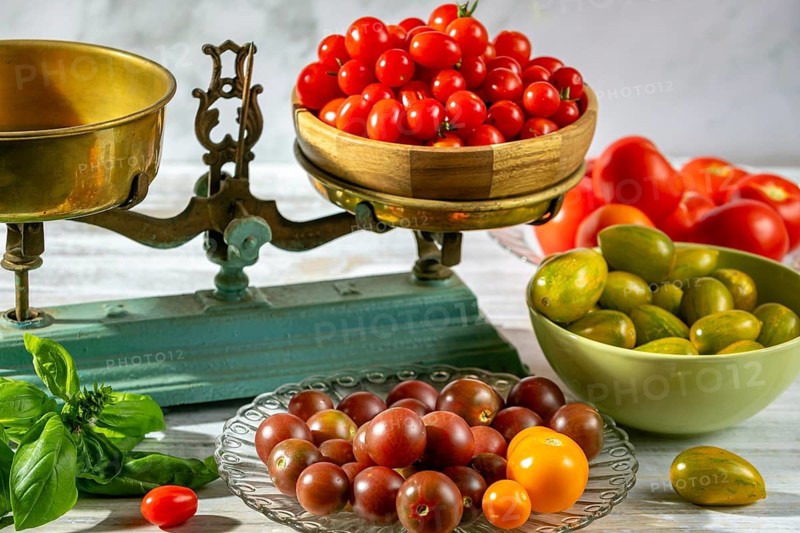 Old scale with fresh tomatoes and basil, rustic arrangement, natural colors