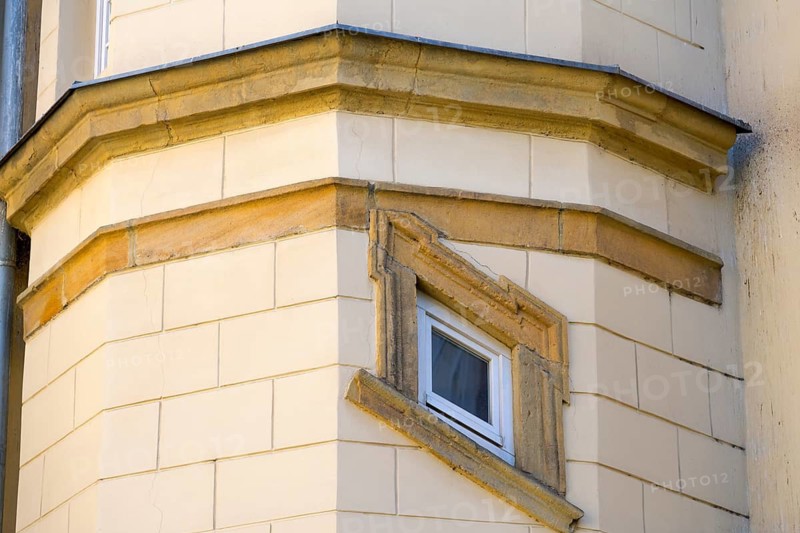 Detailed view of a façade with sandstone-colored elements and a narrow window, crooked window in the castle, Piast Castle, Legnica, Liegnitz, Lower Silesian Voivodeship, Poland