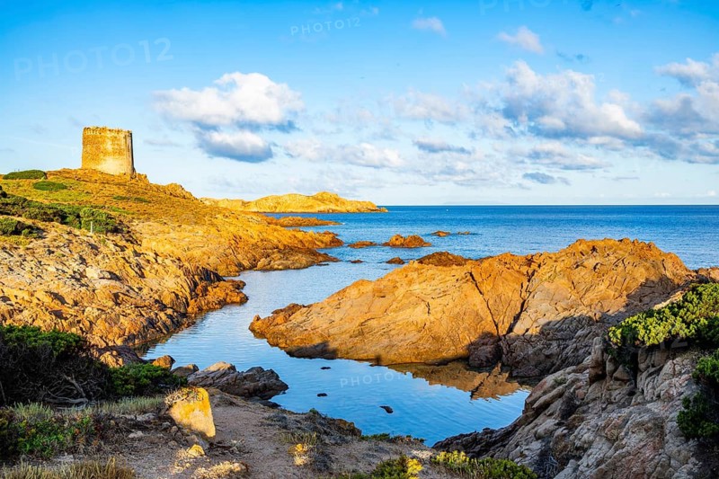An old tower at the coast at Marinedda at sunset, Sardinia, Italy