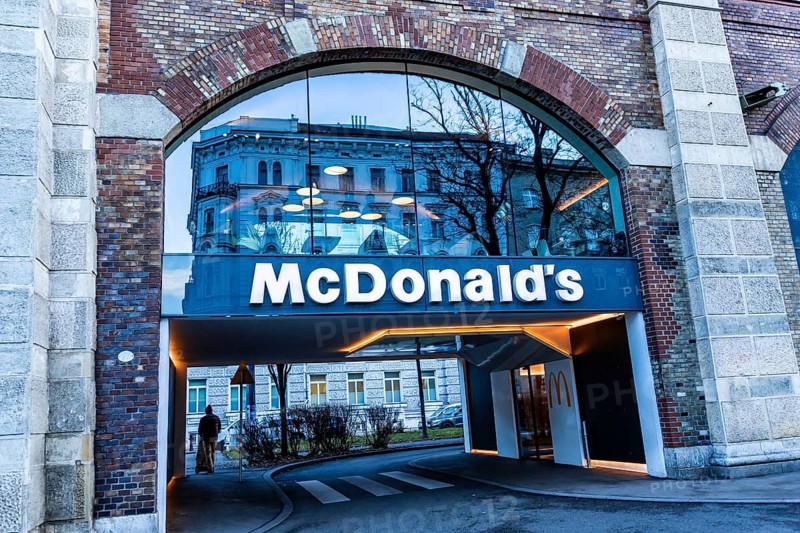 Vienna, Austria - 15 December, 2025: McDonalds restaurant entrance in Vienna, Austria. The sign is prominently displayed with a modern architectural design. Trees are visible in the background