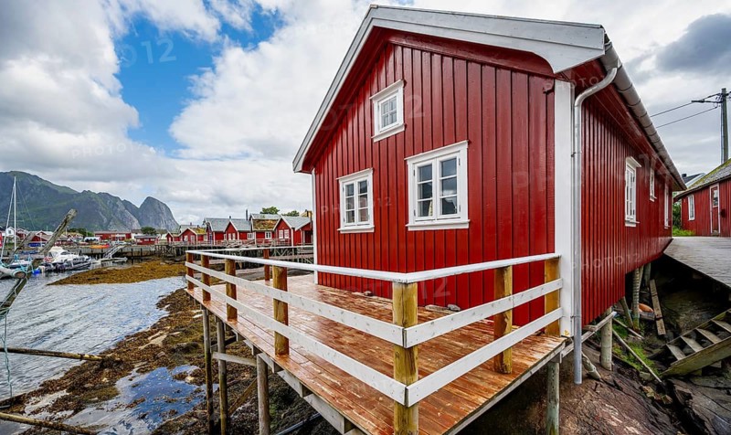 Rorbuer, typical red wooden house on the banks of Reinefjord, Reine, Lofoten, Norway