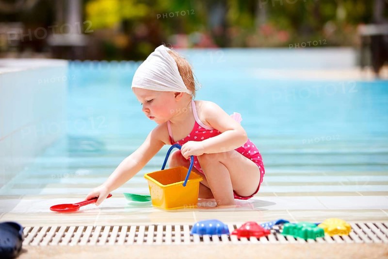A little girl playing at the pool, La Digue, Indian Ocean, Seychelles