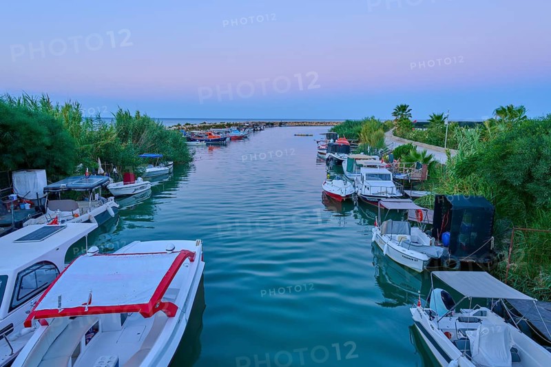 Boats are moored along a quiet river surrounded by lush vegetation at dawn, marina, Evrenseki, Manavgat, Antalya, Turkish Riviera, Mediterranean Sea, Turkey