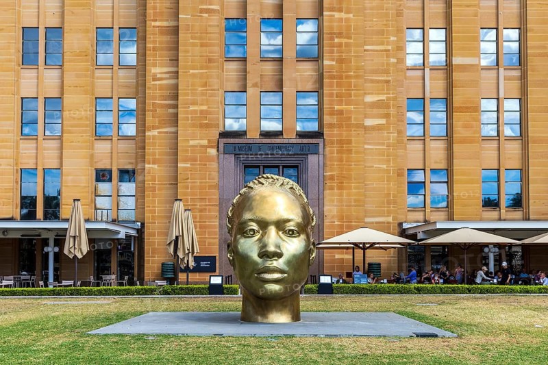 A bronze sculpture head named Ancient Feelings by Thomas J Price outside the Museum of Contemporary Art, Sydney, Australia