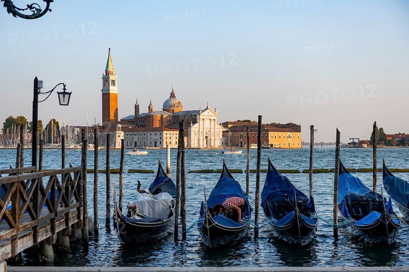 Venetian gondolas, boat launch at St. Mark's Square, San Giorgio Maggiore church in the evening light, Venice, Veneto, Italy